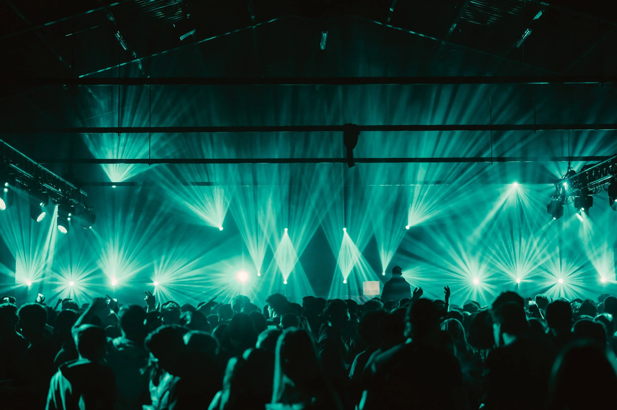 Concert crowd with vibrant green stage lights