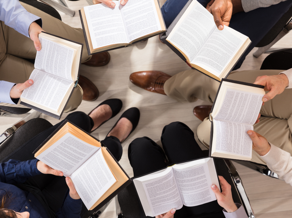People holding paperwork in a circle