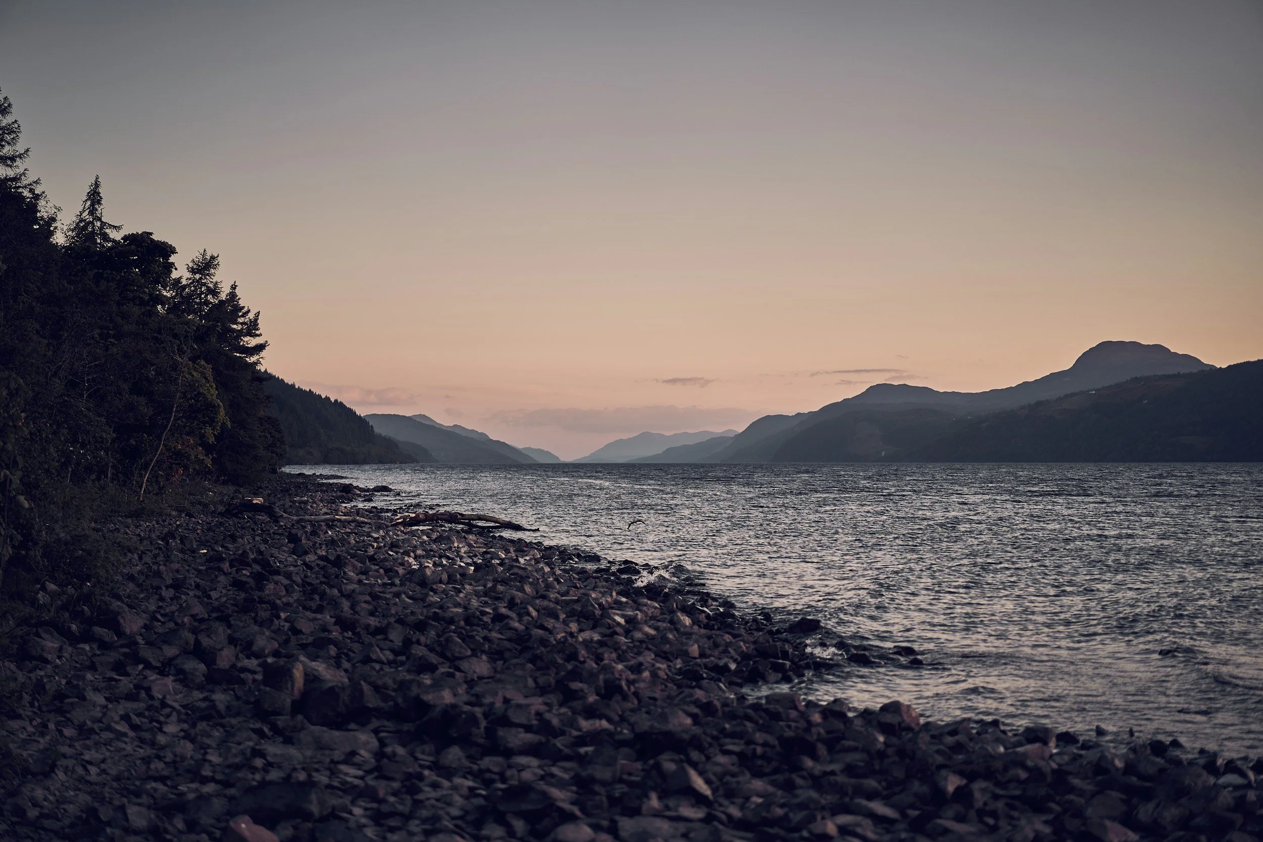Lingering summer twilight over a Scottish loch and mountains