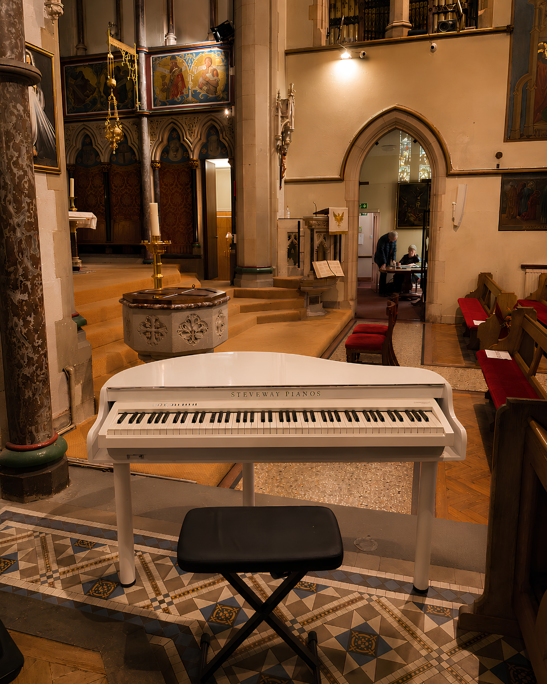 White portable piano set up inside a church for wedding ceremony music – professional wedding pianist serving Hampshire, Berkshire and surrounding areas