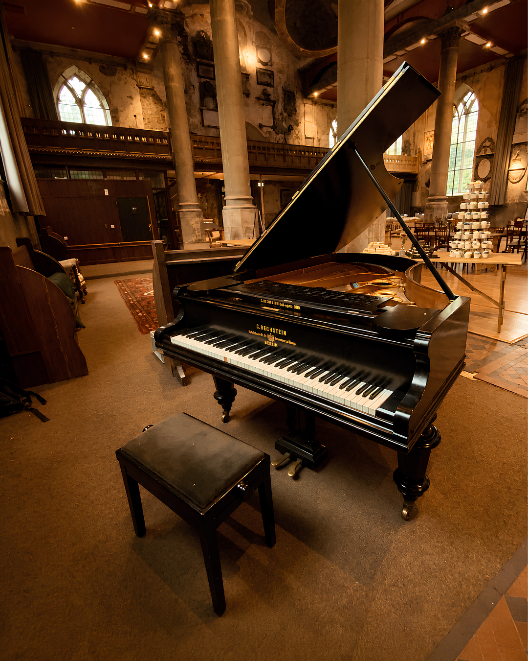 Black grand piano ready for live wedding piano music in an elegant historic venue across Hampshire, Berkshire and the South of England