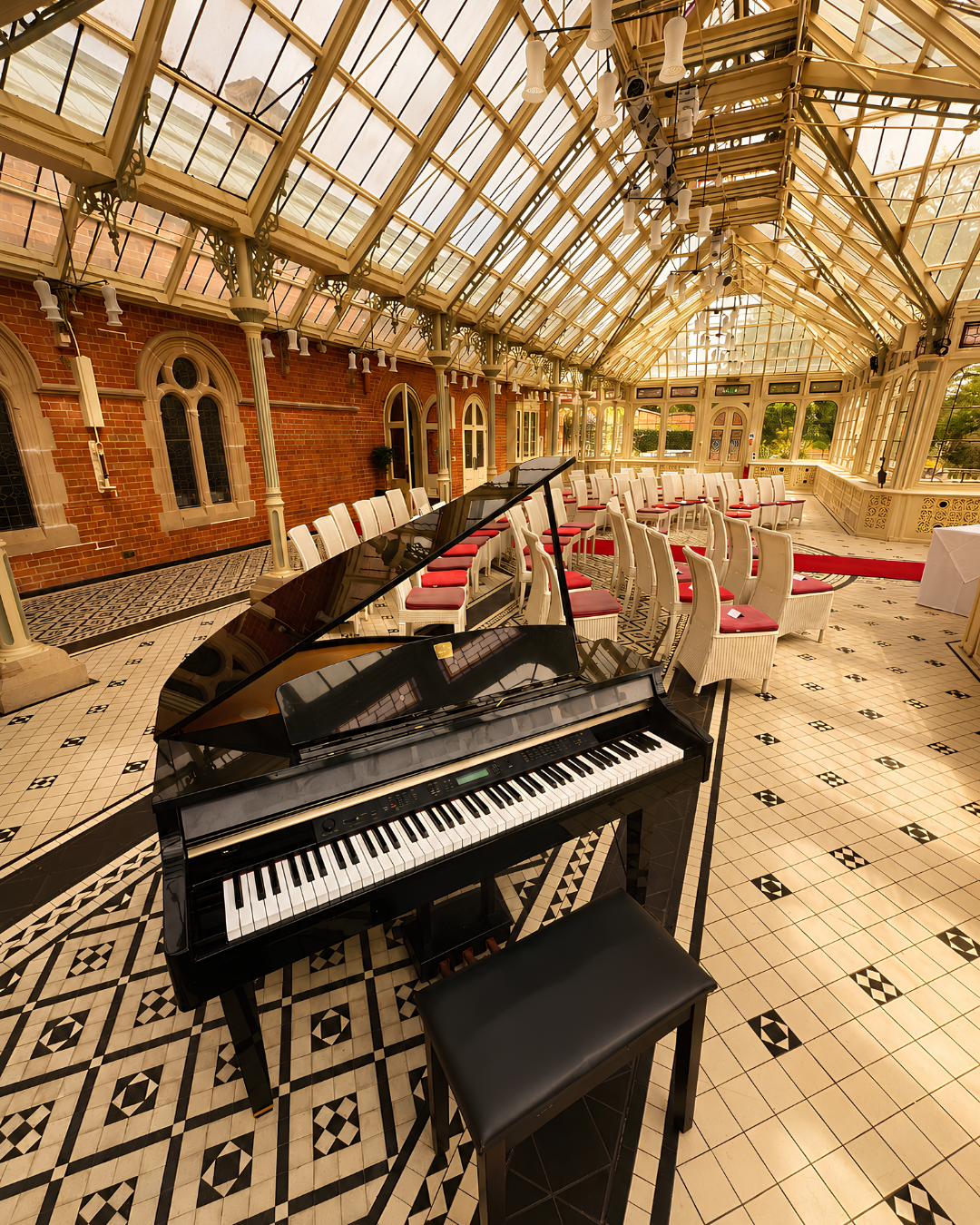 Grand piano set up in a glass conservatory wedding venue for live ceremony and reception music by a professional wedding pianist in Bristol, Bath and the South of England