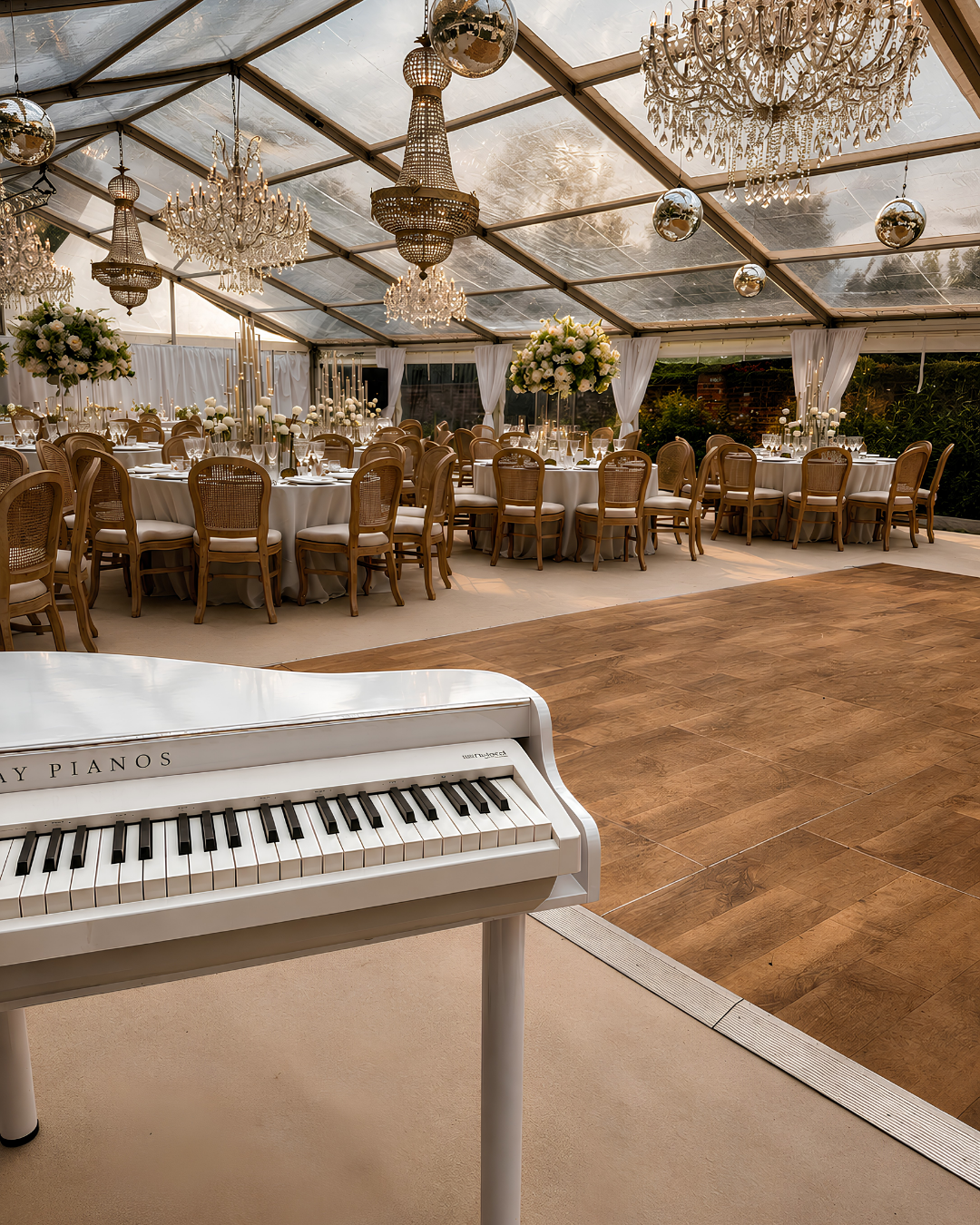 Portable white baby grand piano shell in a marquee wedding reception – live piano music for weddings in Hampshire and Berkshire