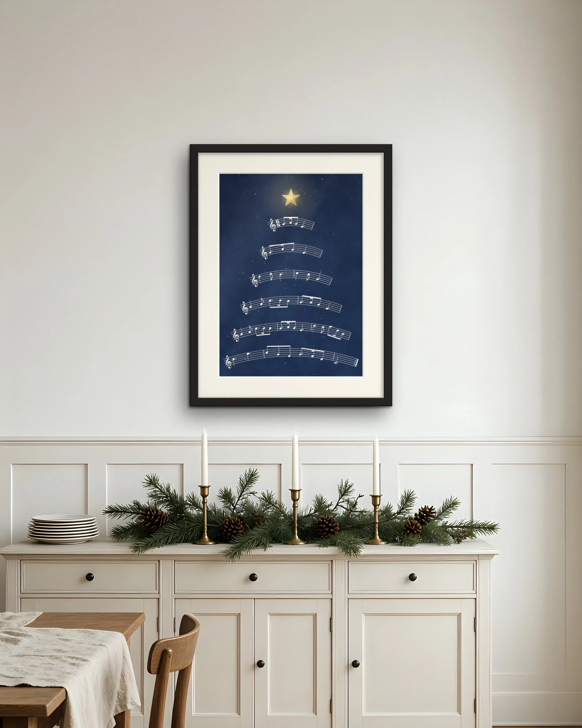 Silent Night Stave Tree Christmas piano wall art print framed above a white dining room sideboard with a Christmas garland