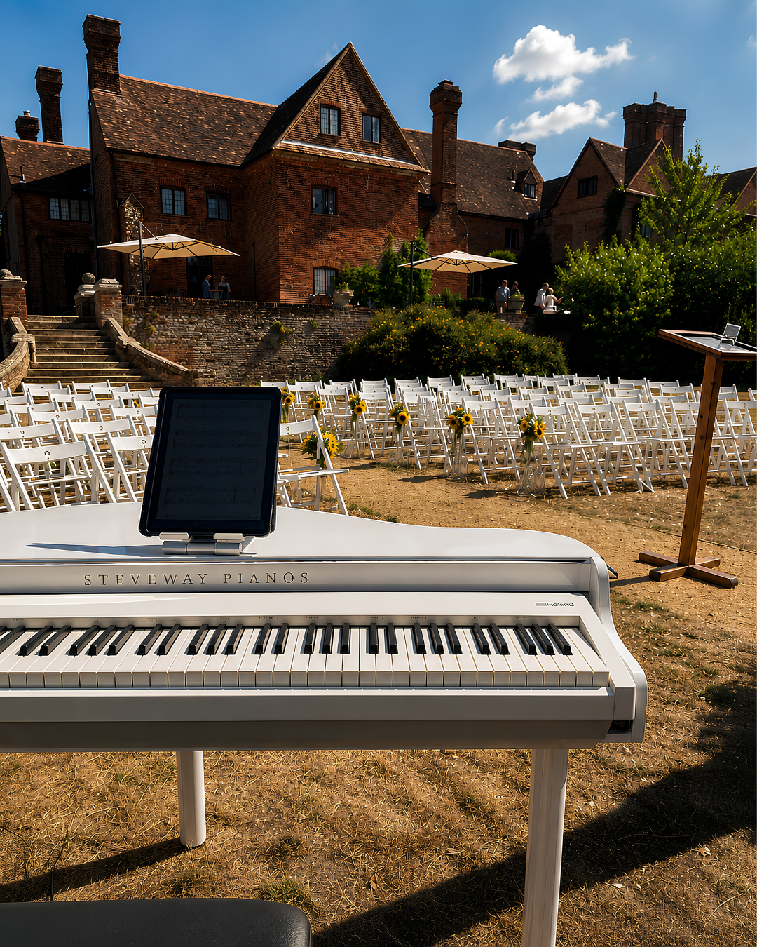 Wedding ceremony piano music at a manor house venue – white baby grand piano shell for outdoor weddings in Berkshire and Gloucestershire