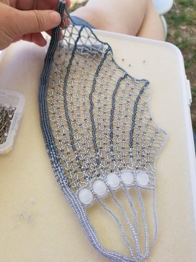 pinning a wing down to work on the netting.jpg