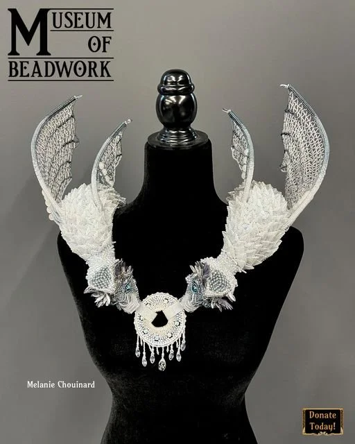 2021 - Empress of the Fog Dragons - this won Gold Medal from FireMountain Gems and was donated to the Museum of Beadwork. Each dragon is contains over 300 beaded scales. The wings are netted glass japanese seed beads and fire polish. The center front