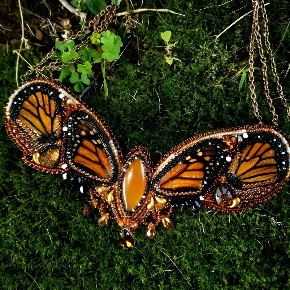 Queen of the Monarchs - preserved monarch butterfly wings from a naturally deceased butterfly are set into this bead embroidery necklace. Orange calcite, alamandine garnet and glass beads make up the rest of the design.