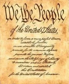 Close-up of the United States Constitution's preamble, displaying the words "We the People" at the top.