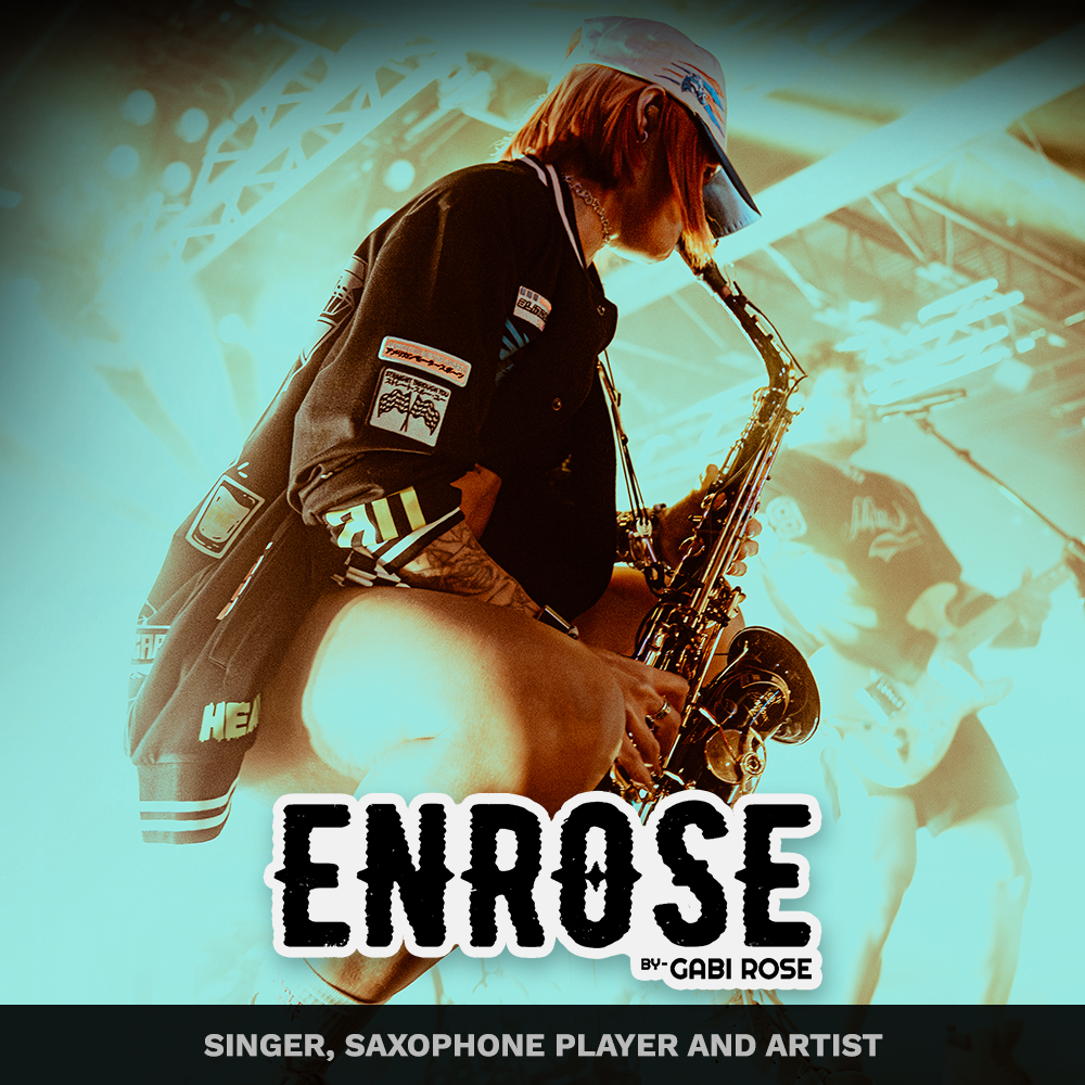 A woman with short hair and a baseball cap playing a saxophone on stage during a concert, with a blurred background of another musician and stage equipment.