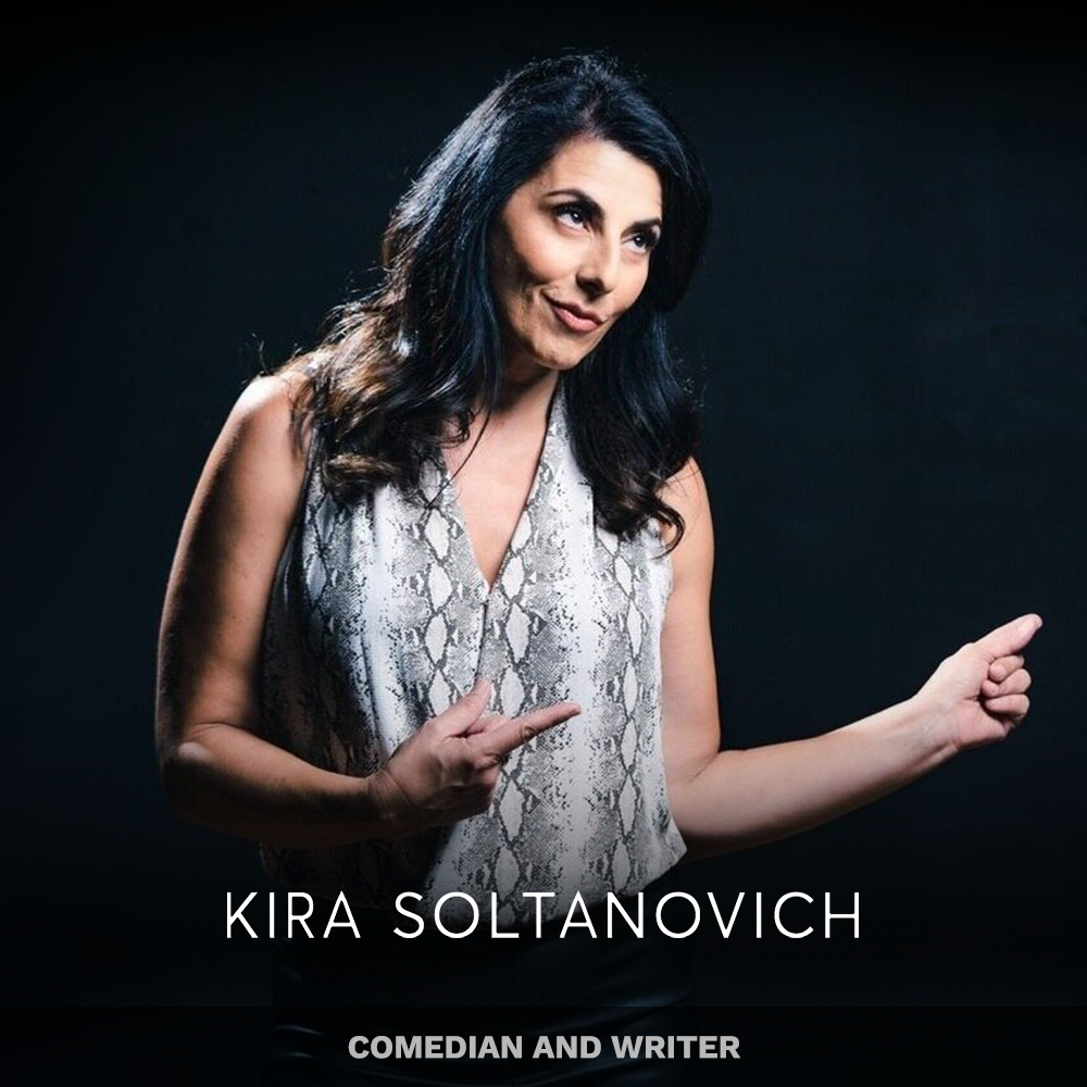 Kira Soltanovich, comedian and writer, posing with a playful expression and pointing to her right with both hands, against a black background.