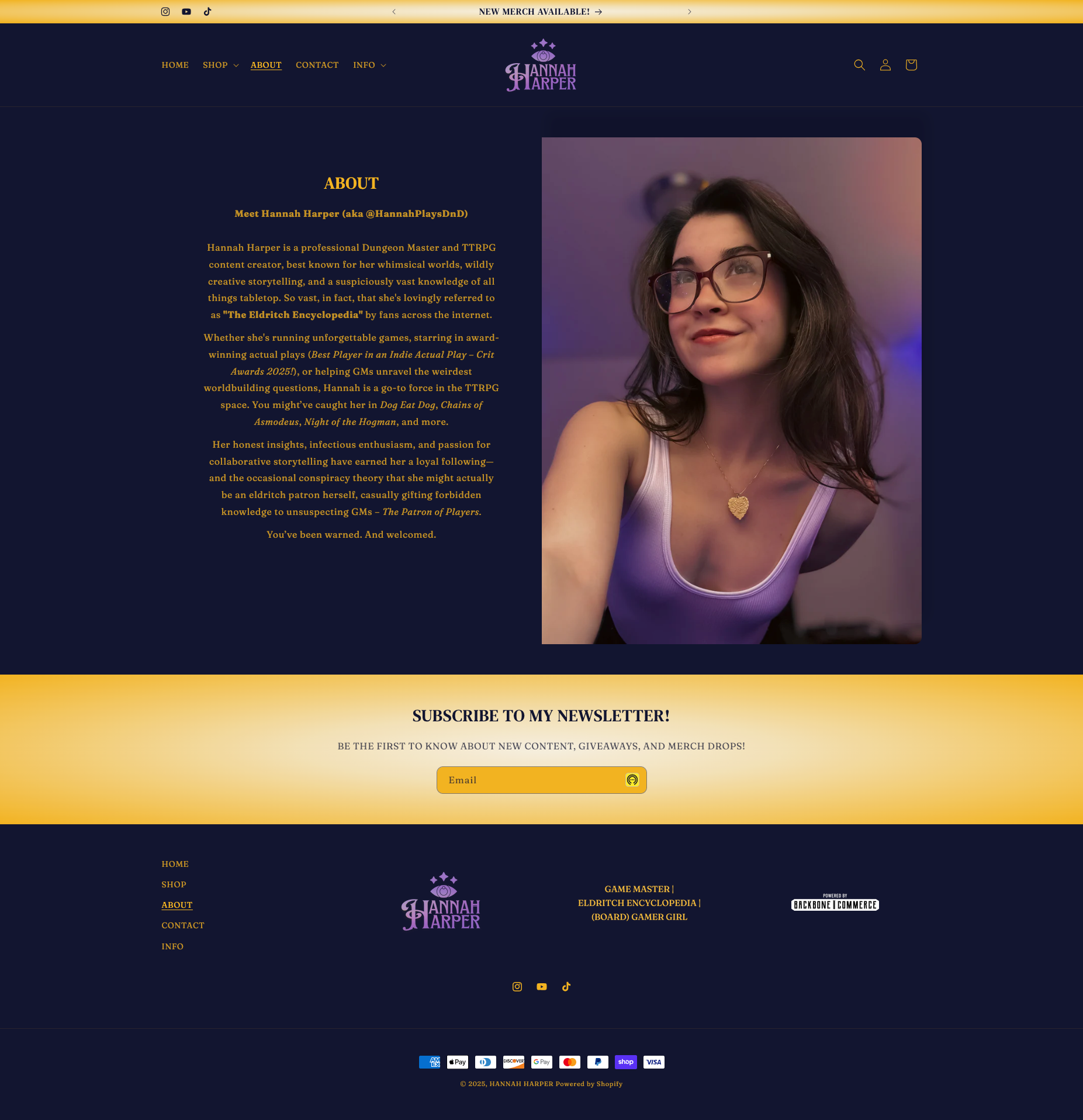 Screenshot of a personal website homepage featuring a photo of a young woman with dark hair and glasses, and the website's branding for Hannah Harper, a content creator and game master, with navigation links and subscription options.