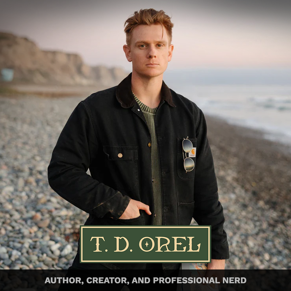 A man with red hair and a serious expression standing on a pebble beach with cliffs and the ocean in the background at sunset. He is wearing a black jacket, a green shirt, and sunglasses hanging from his jacket pocket. Text overlays include "T. D. Or