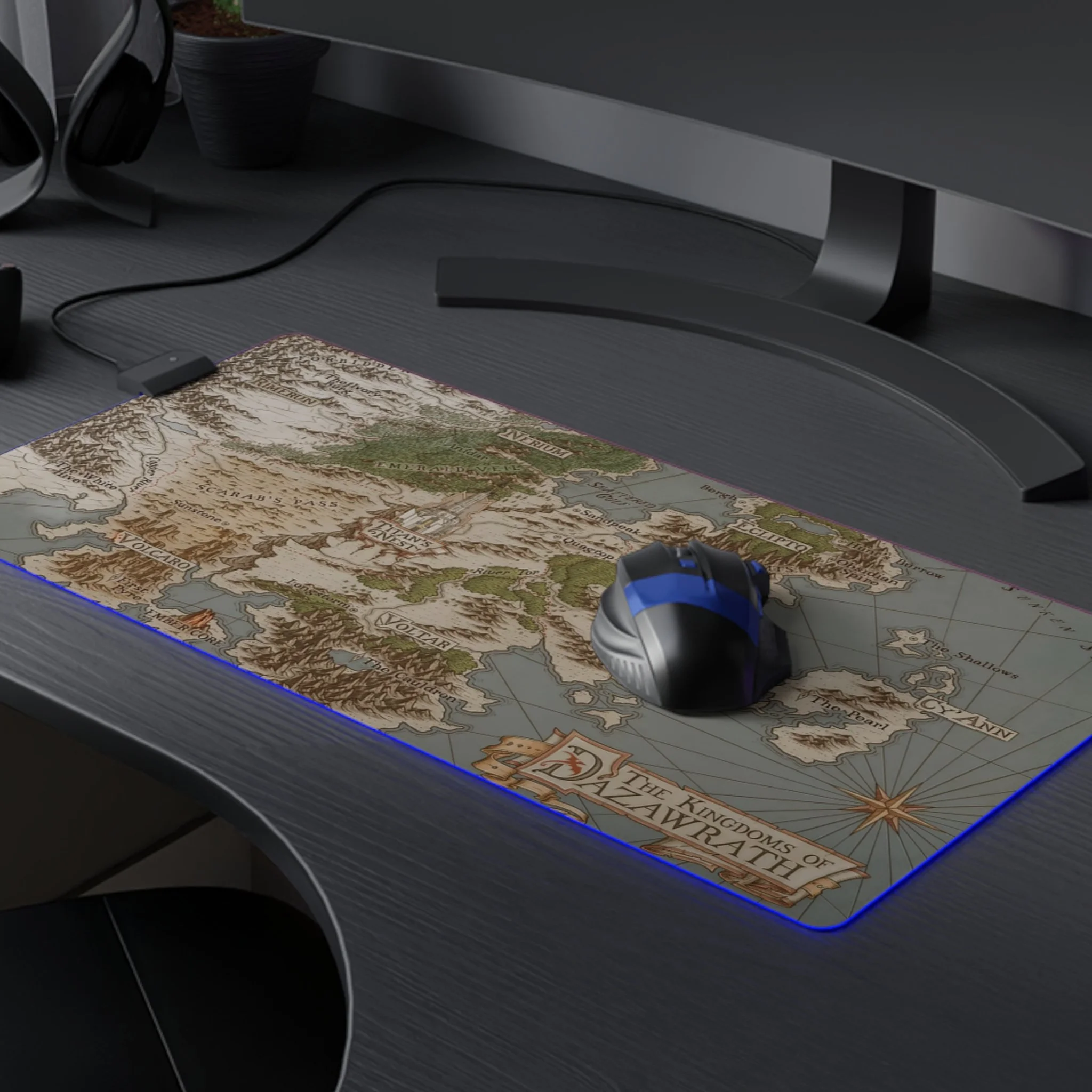 A close-up of a computer desk with a monitor, a sketchbook, and a mouse. The desk has a sleek, modern design with a silver color and illuminated blue edges.