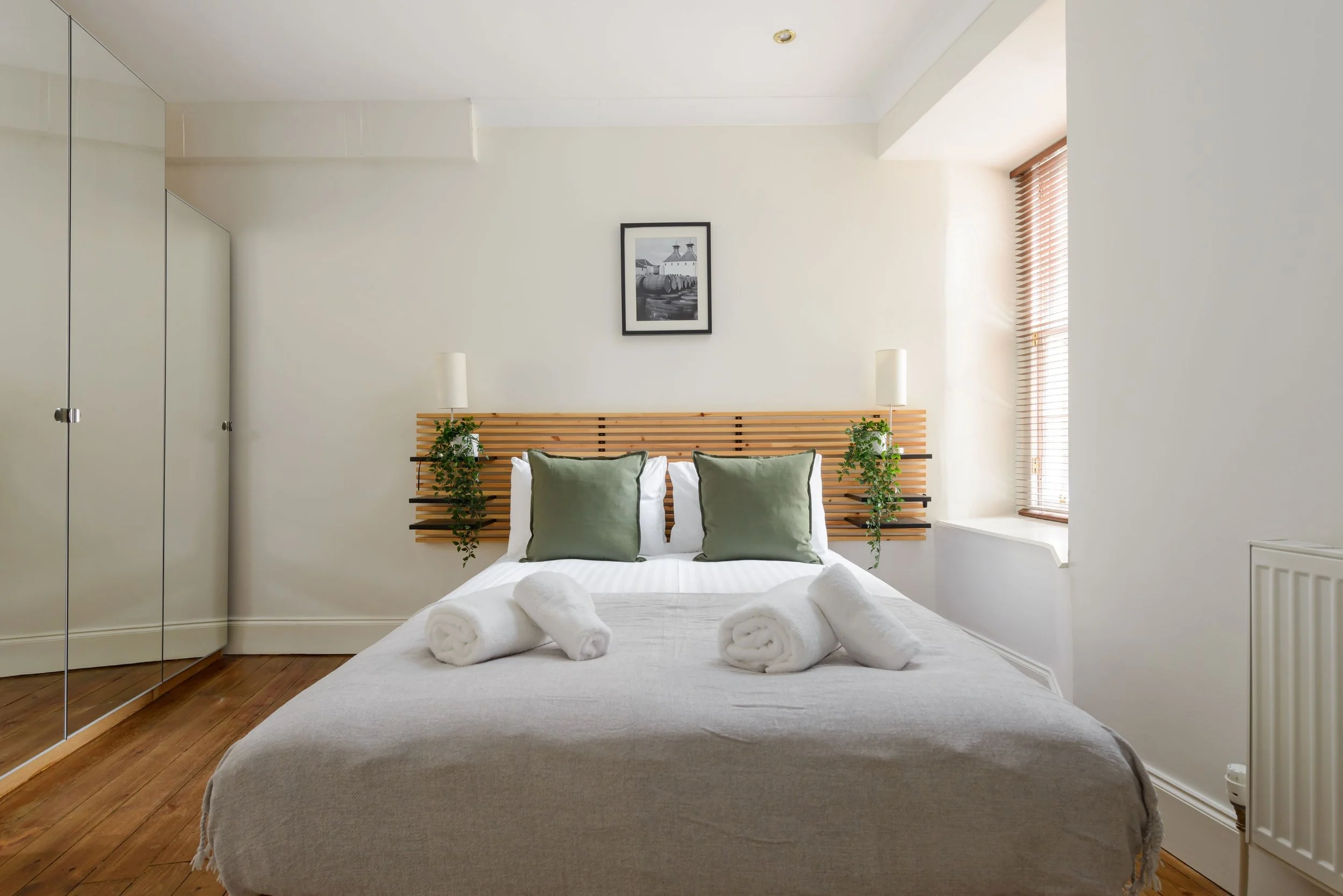 a white bed with a bamboo header