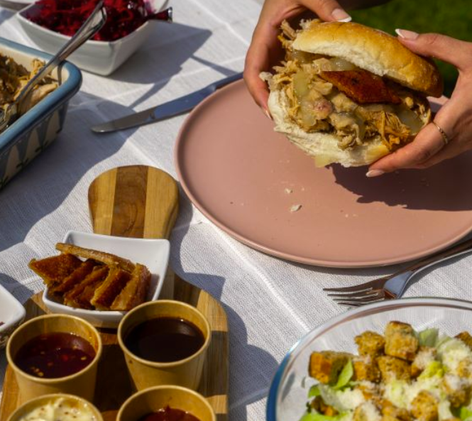 A Pulled pork burger on a pink plate