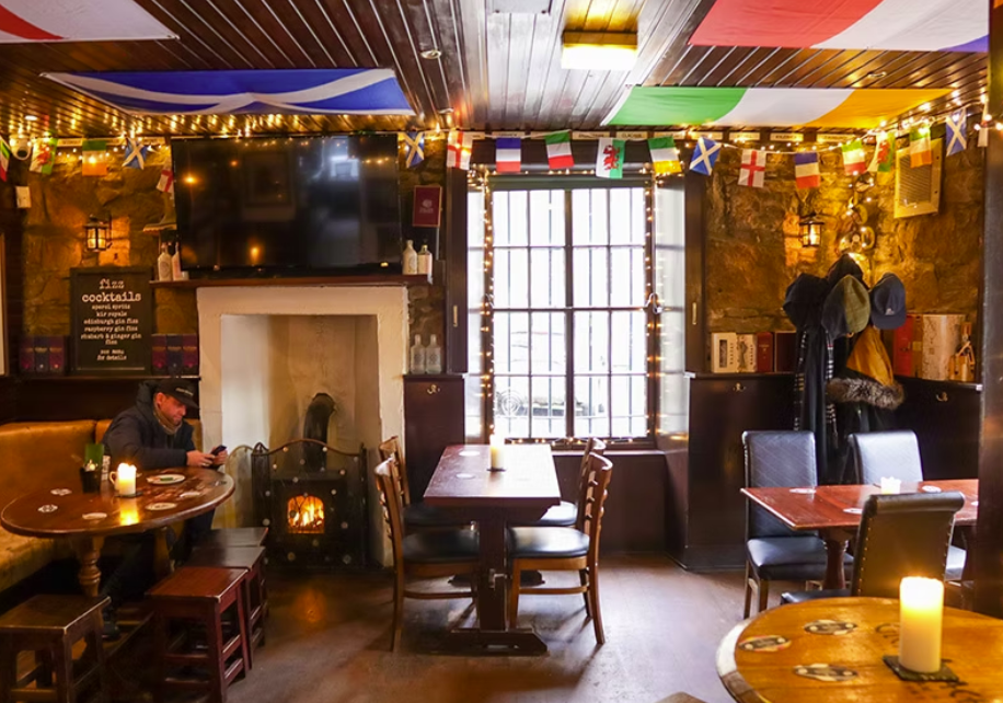 A Warm lighted pub with flags