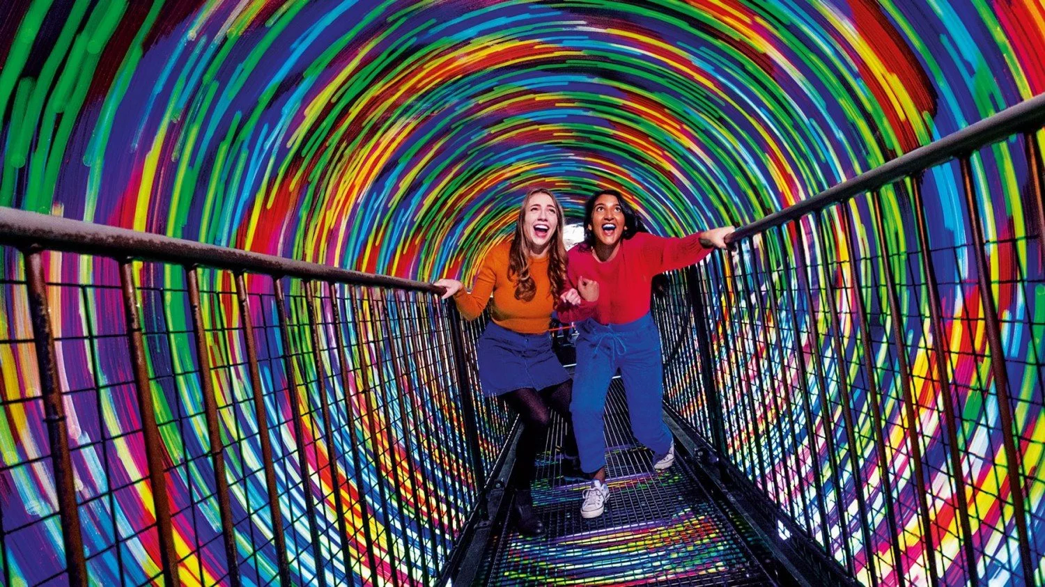 a metal bridge going through a patterned tunnel.