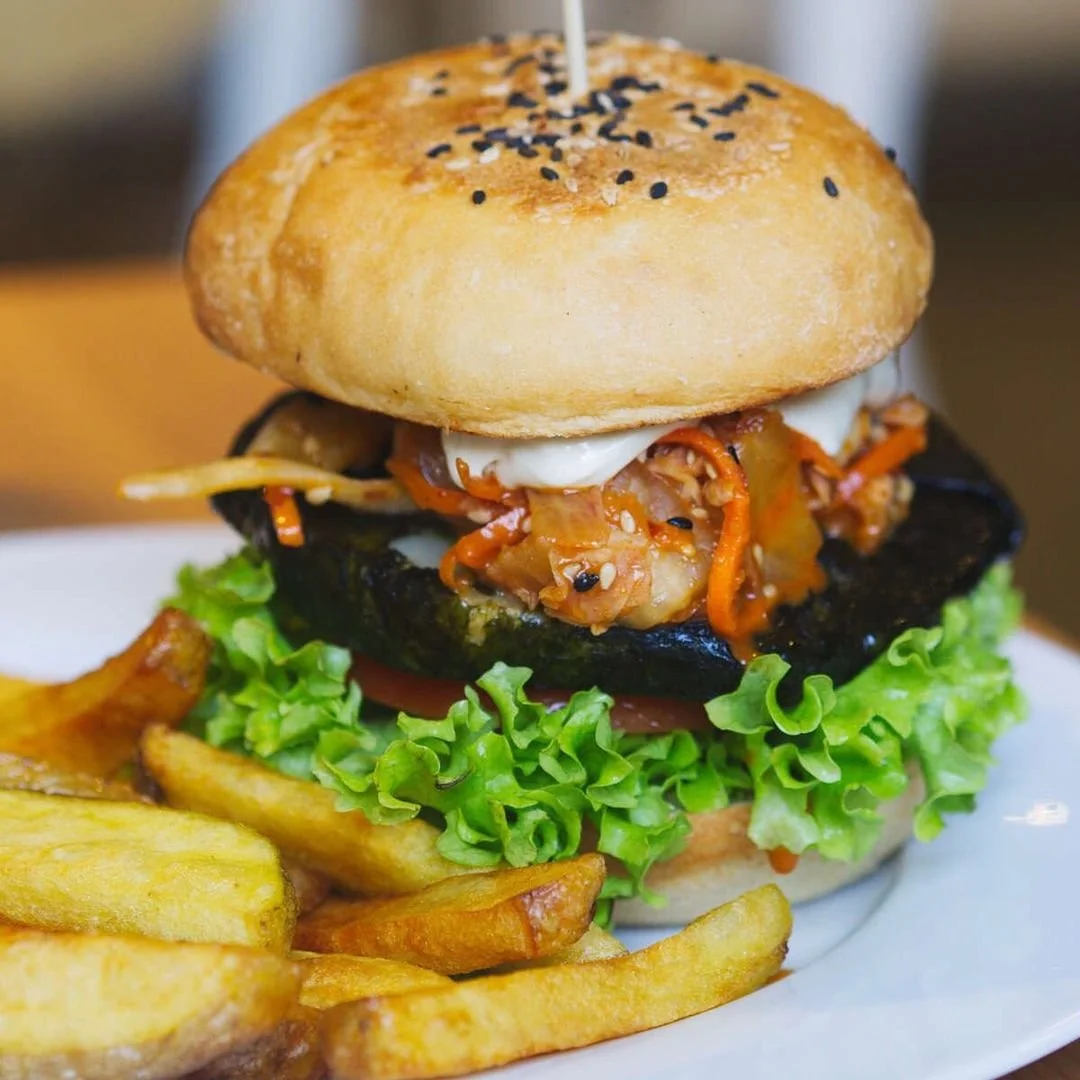 A large beef burger with a stick through