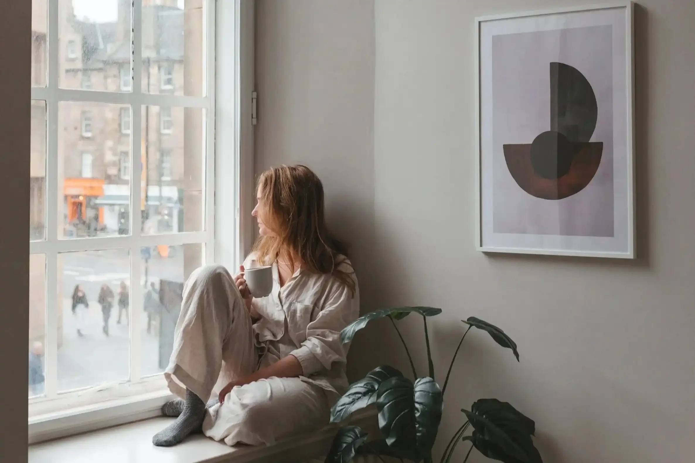 Girl sat at museum apartments window.