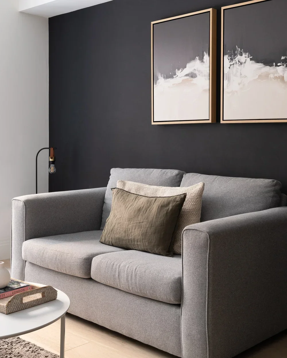 A Grey sofa infront of a grey wall
