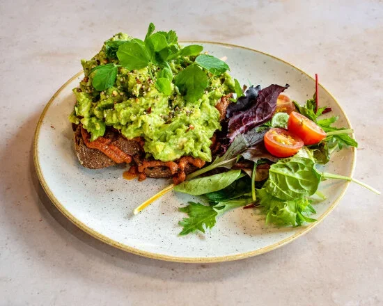 a plate with avocado toast and salad