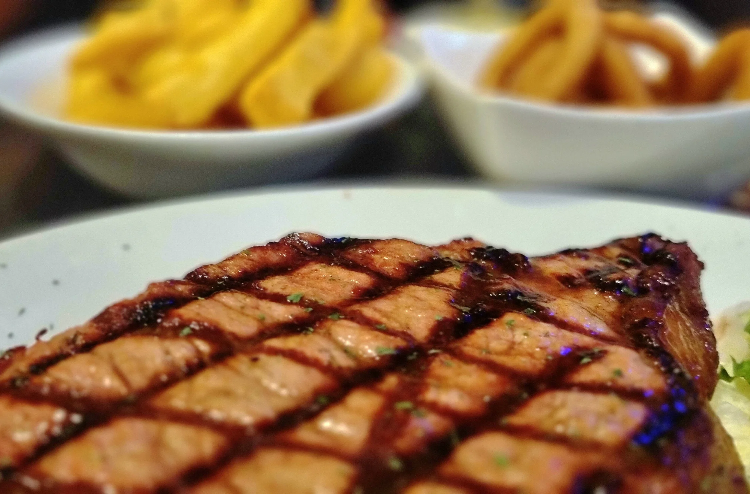 a zoomed in steak with fries