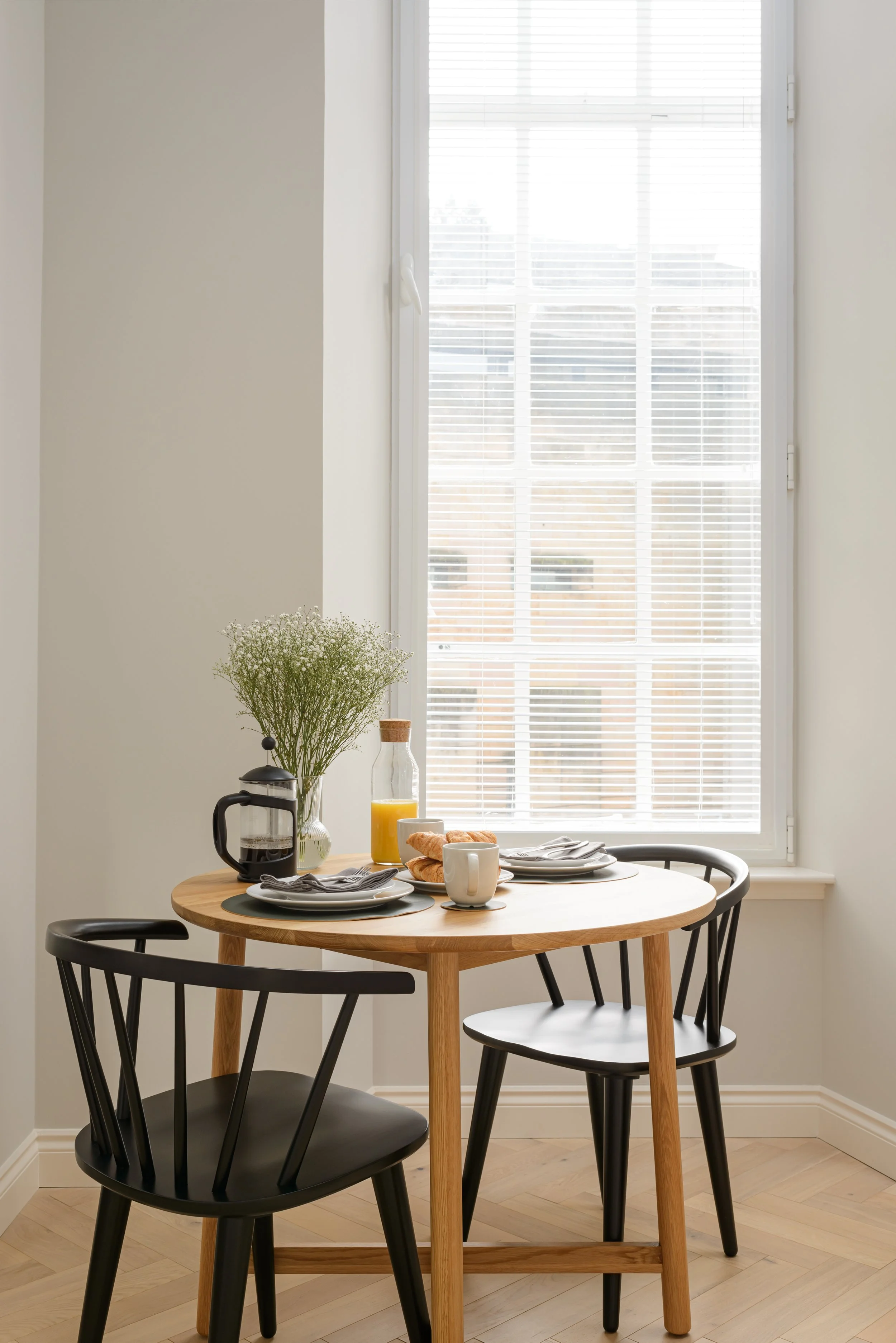 Two dining chairs by a window