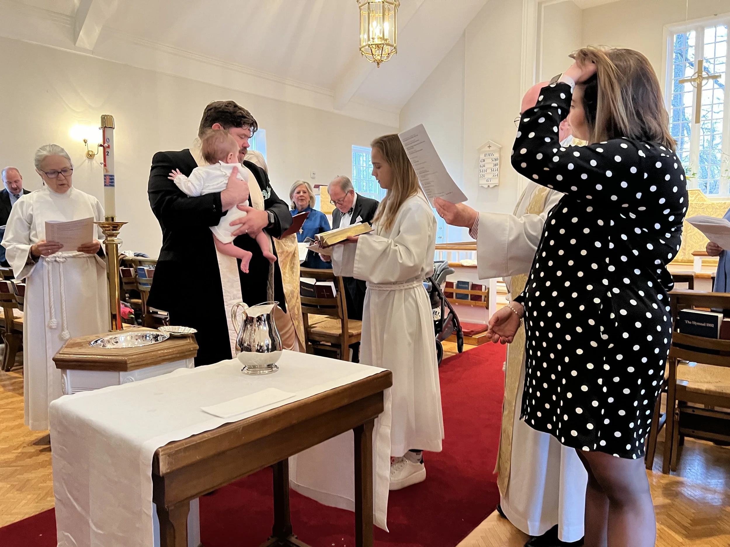 A baby is baptized at Saint Peter's Episcopal Church. Any age may be baptized