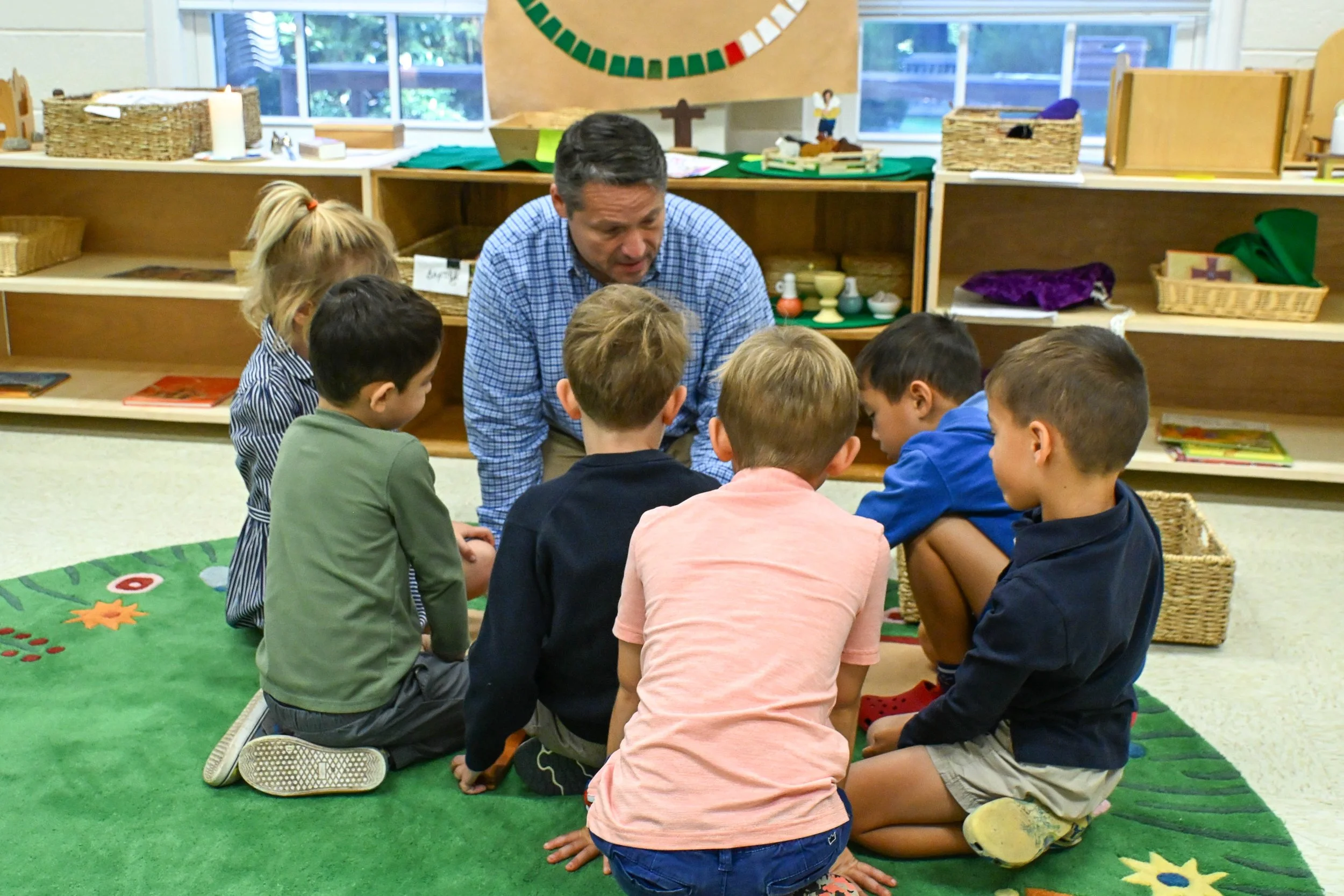 A man teaching children in Godly Play.