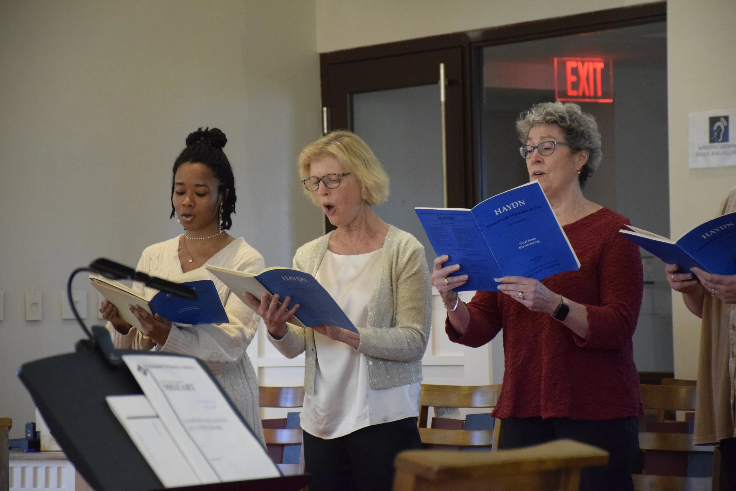 Women sing at a choral concert