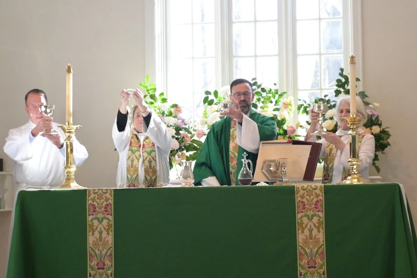 A priest giving a homily to children