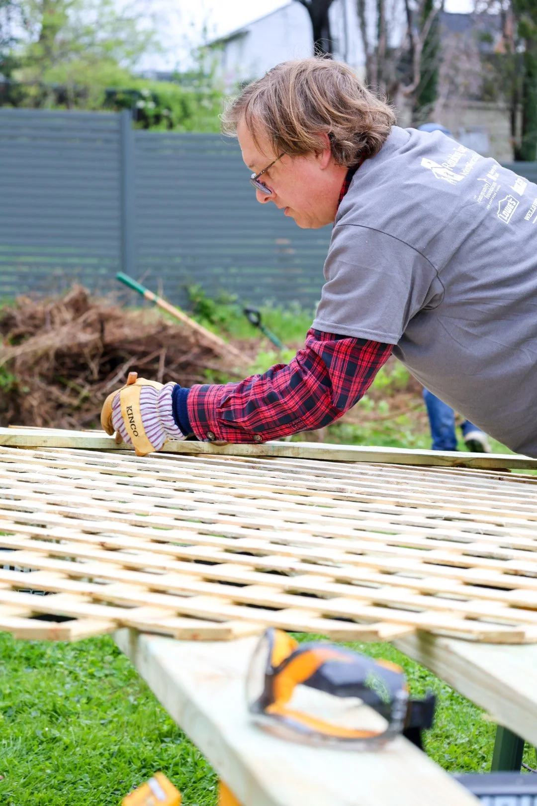 A person fixing a fence