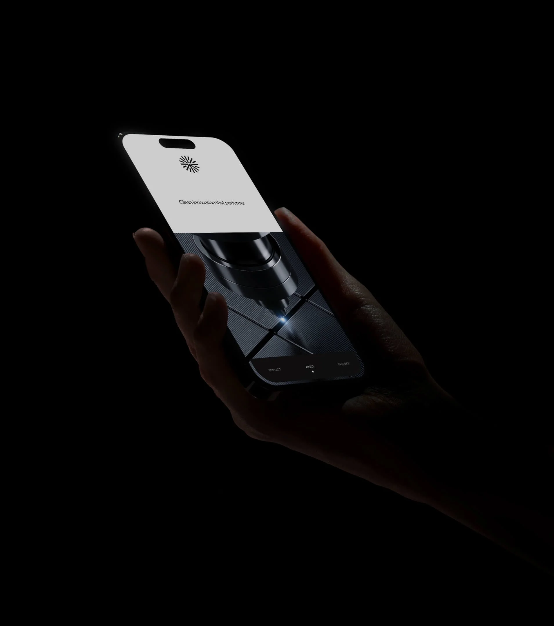 A person holding a smartphone with a cleaning robot shown on the screen, and the visibly illuminated robot is performing a cleaning task.