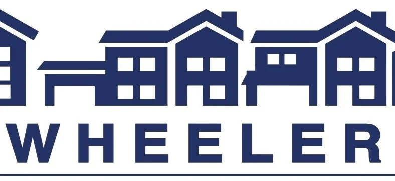 Stylized graphic of multiple houses with the word 'Wheeler' underneath in bold capital letters.