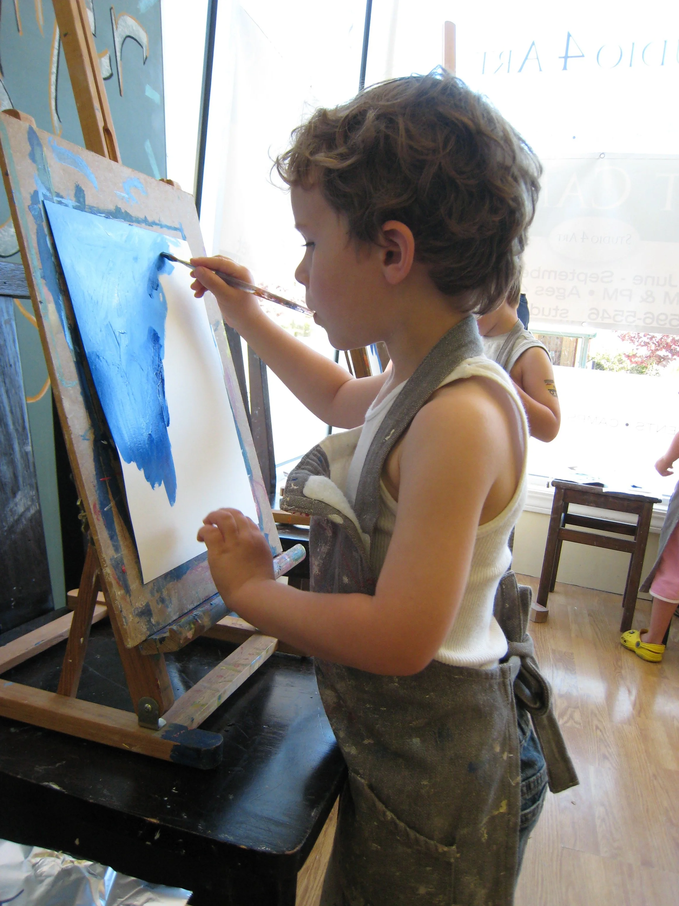 Kaden painting at easel preschool class.JPG