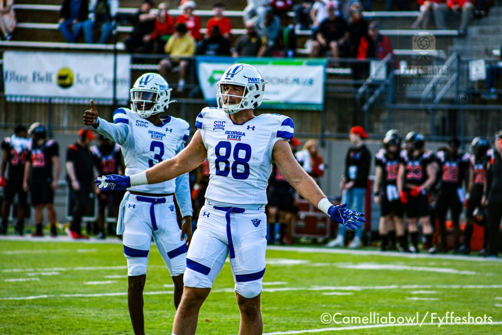 Georgia State football players in white uniforms celebrating on the field during a game