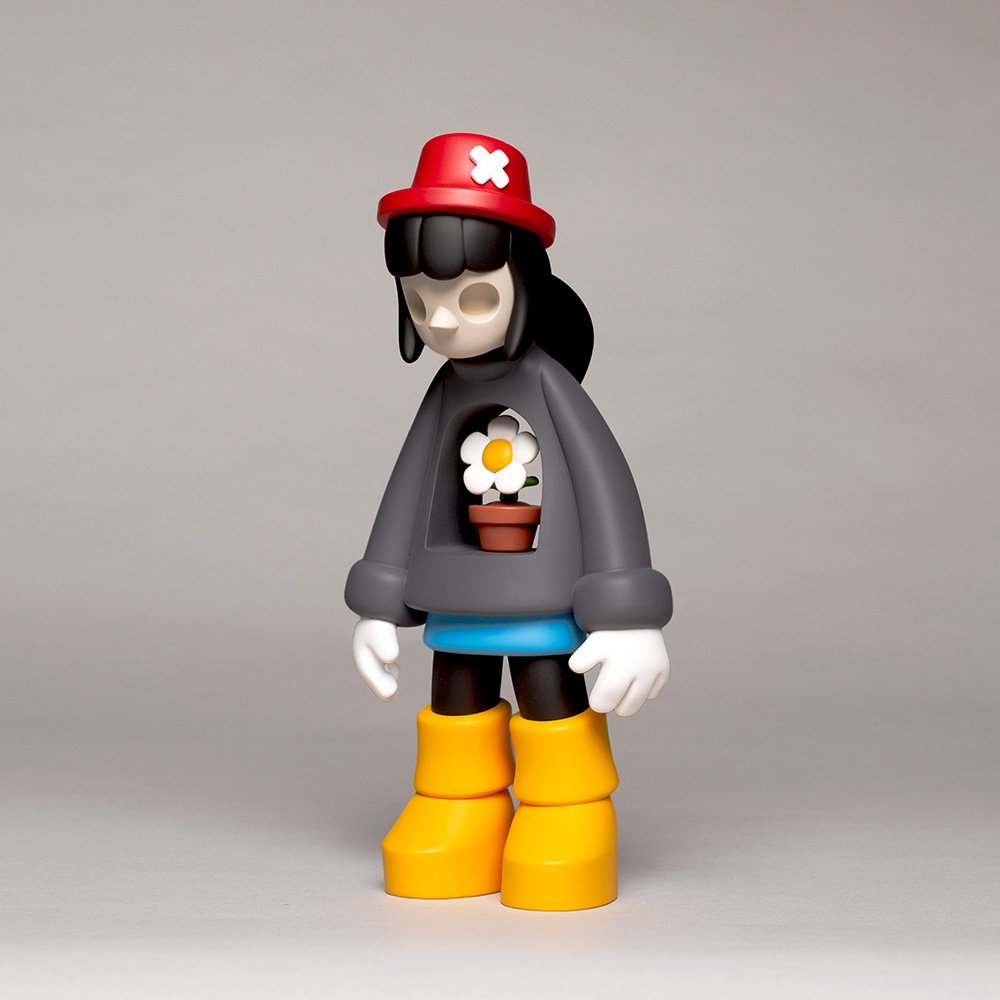 Miss Bliss limited edition designer art toy in red and yellow, 3/4 front view, featuring bold color contrasts and resin detailing from the Exploration of Void series