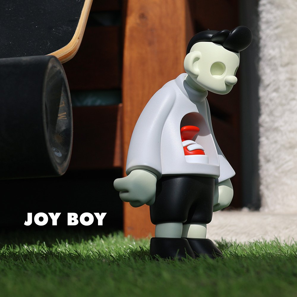 Joy Boy limited edition designer art toy in off-white, side view, featuring sleek resin design and minimalist detailing, part of the Joy Boy series