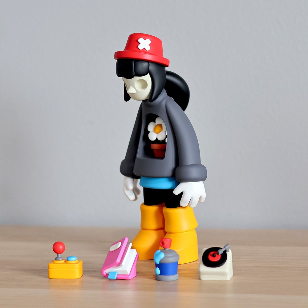 Miss Bliss limited edition designer art toy in red and yellow, angled view, showcasing vibrant resin colors and detailed design from the Exploration of Void series
