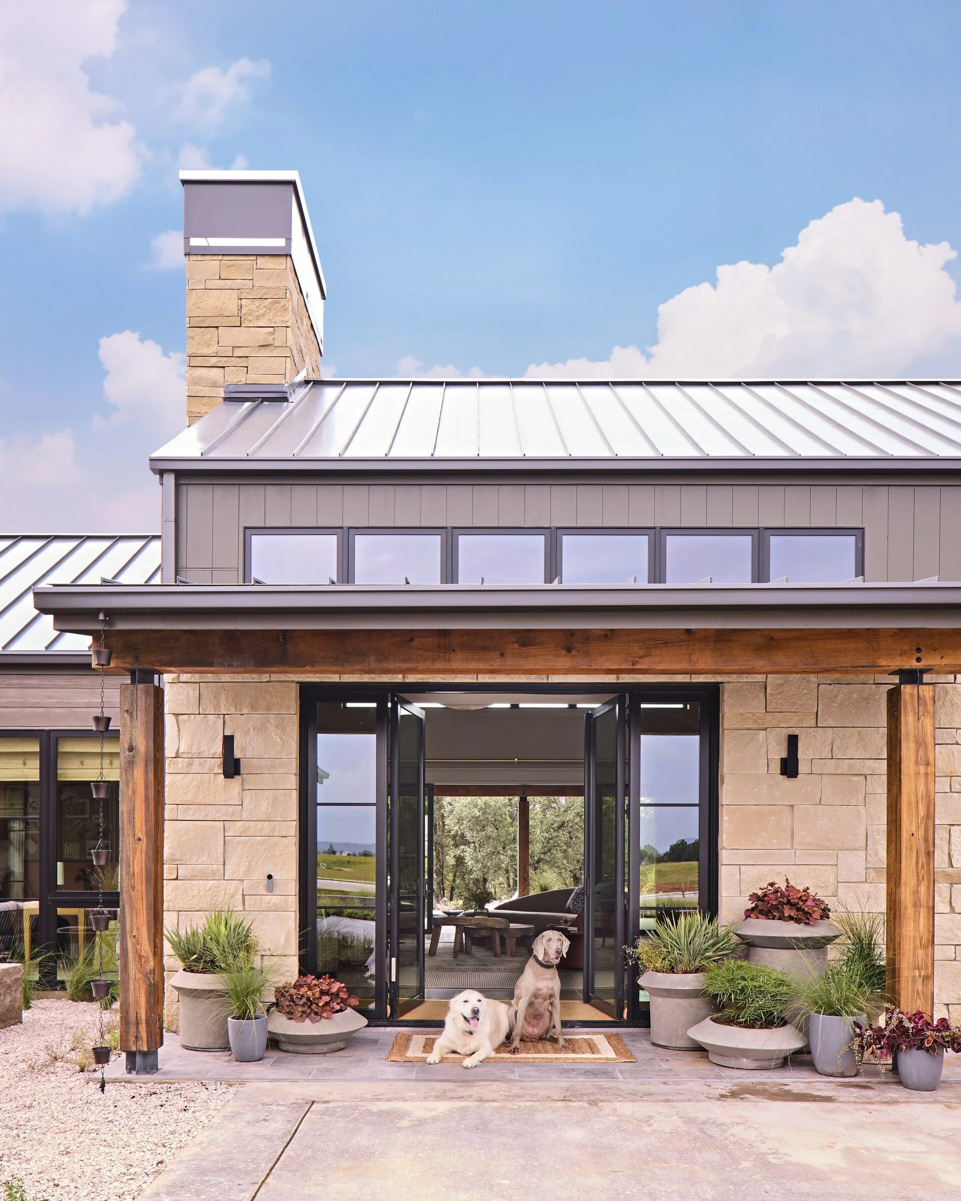 Entry porch with dogs, Southern Living Idea House Fredericksburg landscape design by Melissa Gerstle Design.