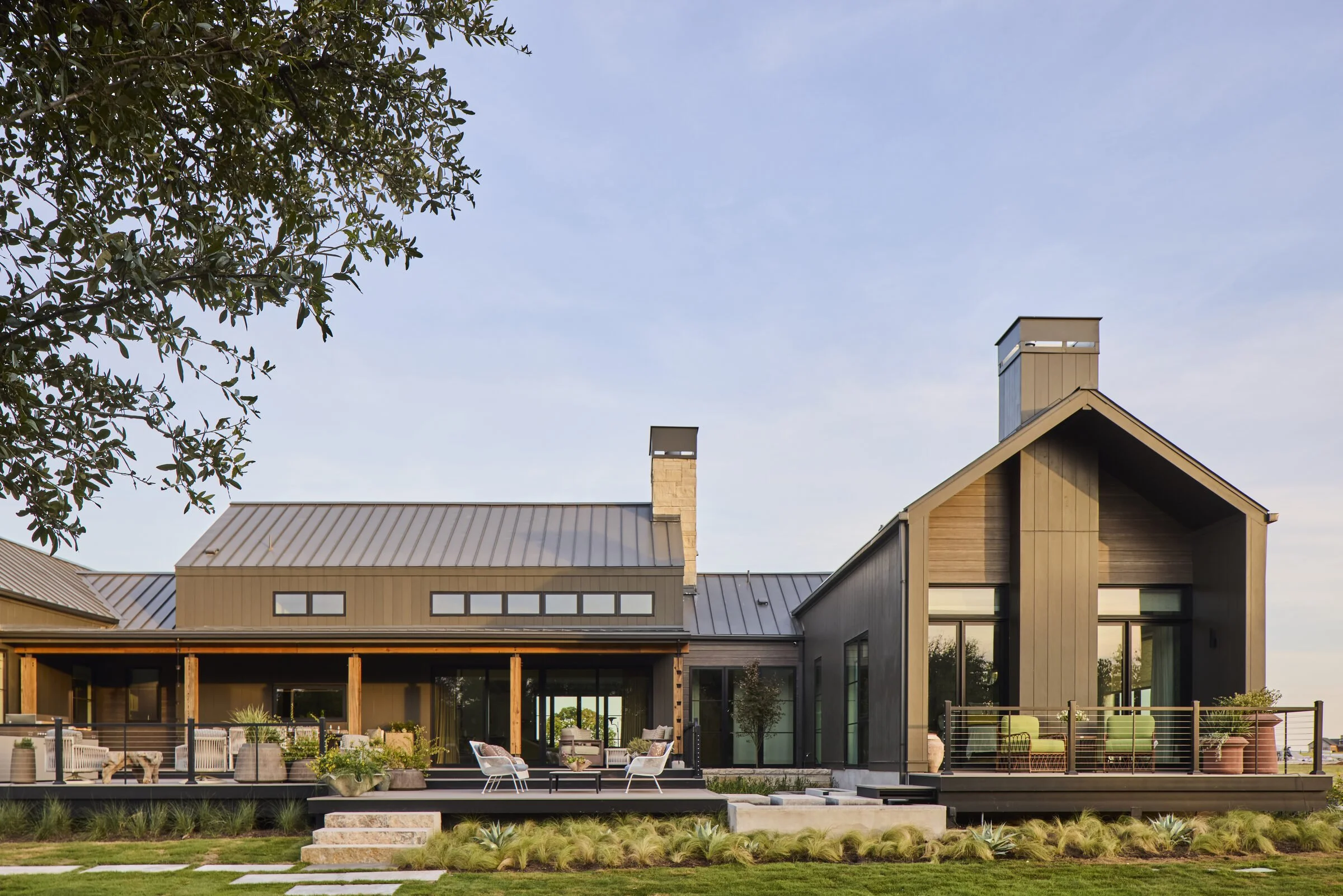 Rear facade at twilight, Southern Living Idea House Fredericksburg landscape design by Melissa Gerstle Design.