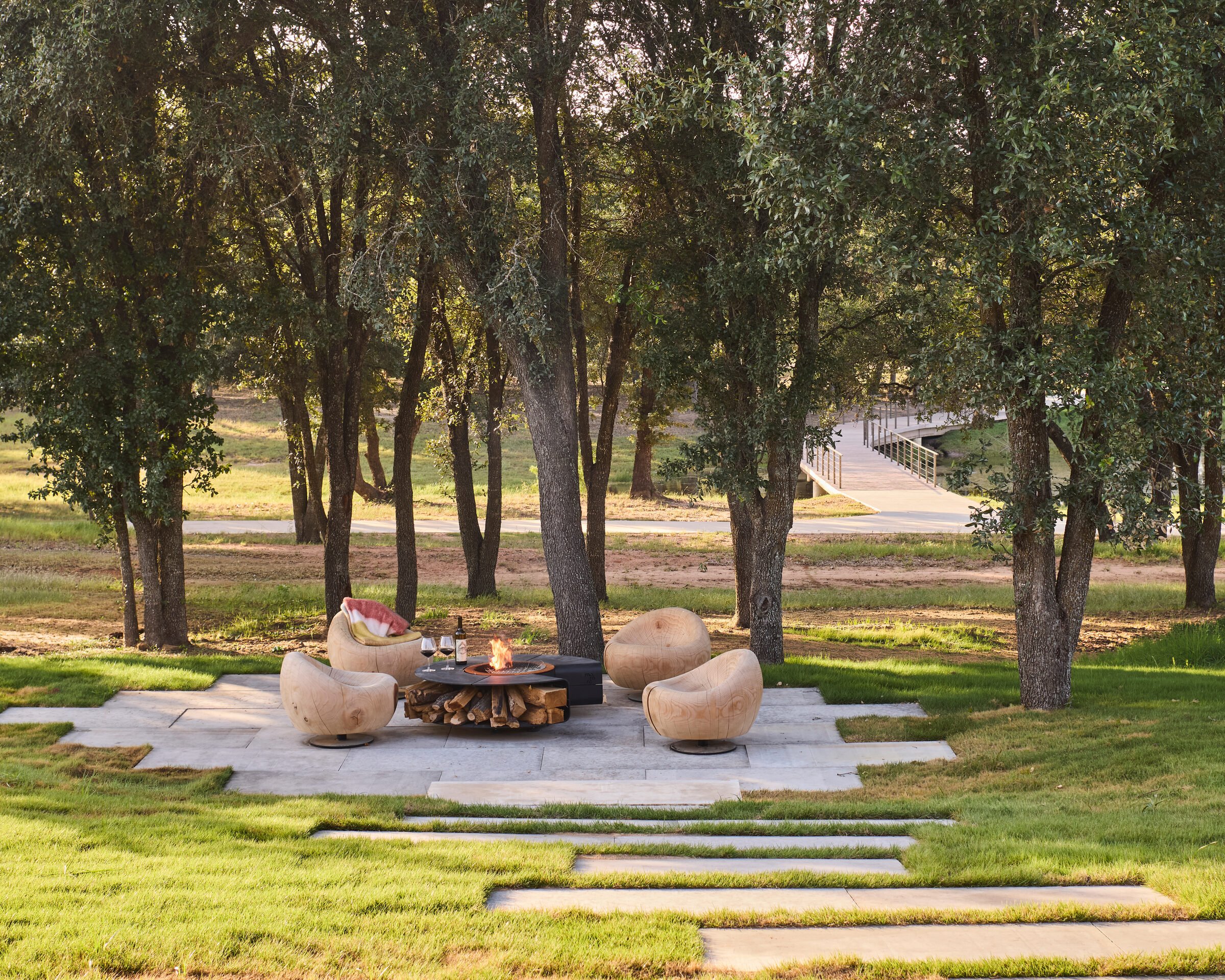 Oak grove fire pit lounge area, Southern Living Idea House Fredericksburg landscape design by Melissa Gerstle Design.