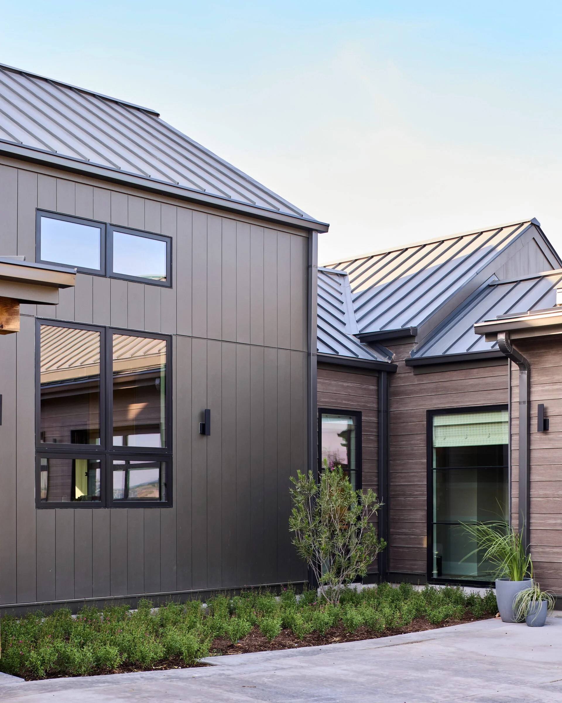 Facade detail with native stone and siding, Southern Living Idea House Fredericksburg landscape design by Melissa Gerstle Design.