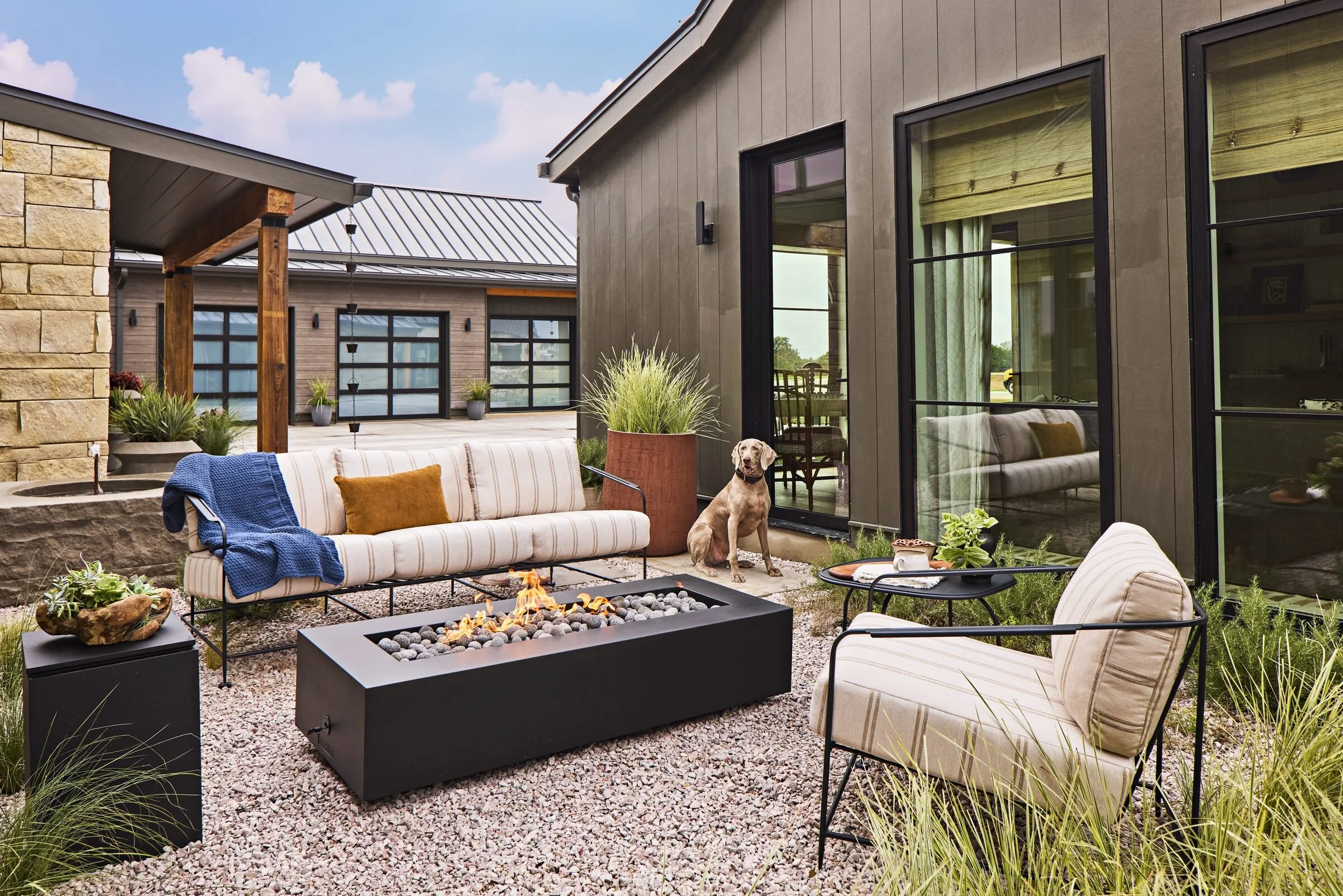 Courtyard fire pit and dog, Southern Living Idea House Fredericksburg landscape design by Melissa Gerstle Design.