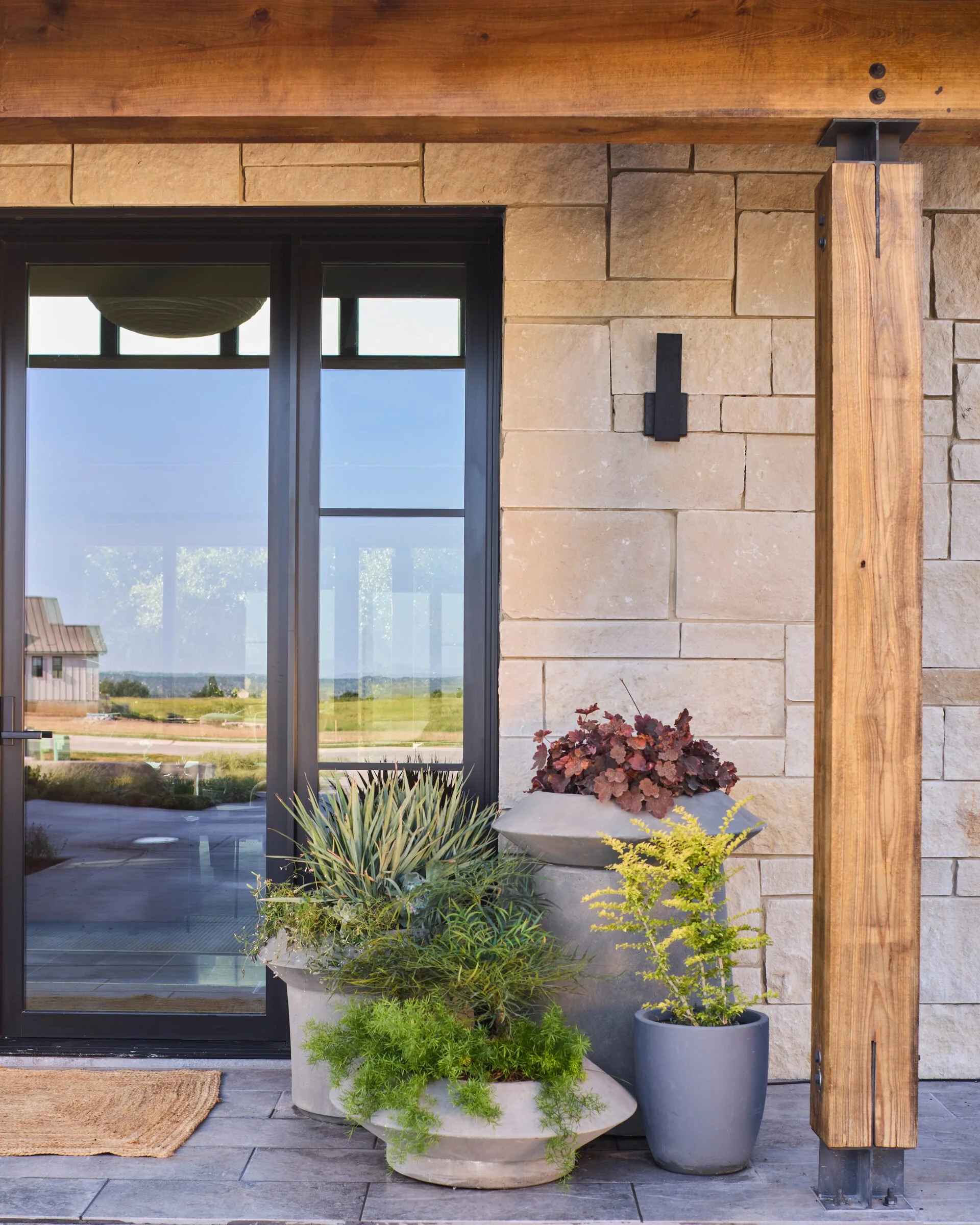 Entry planters with limestone hardscape, Southern Living Idea House Fredericksburg landscape design by Melissa Gerstle Design.