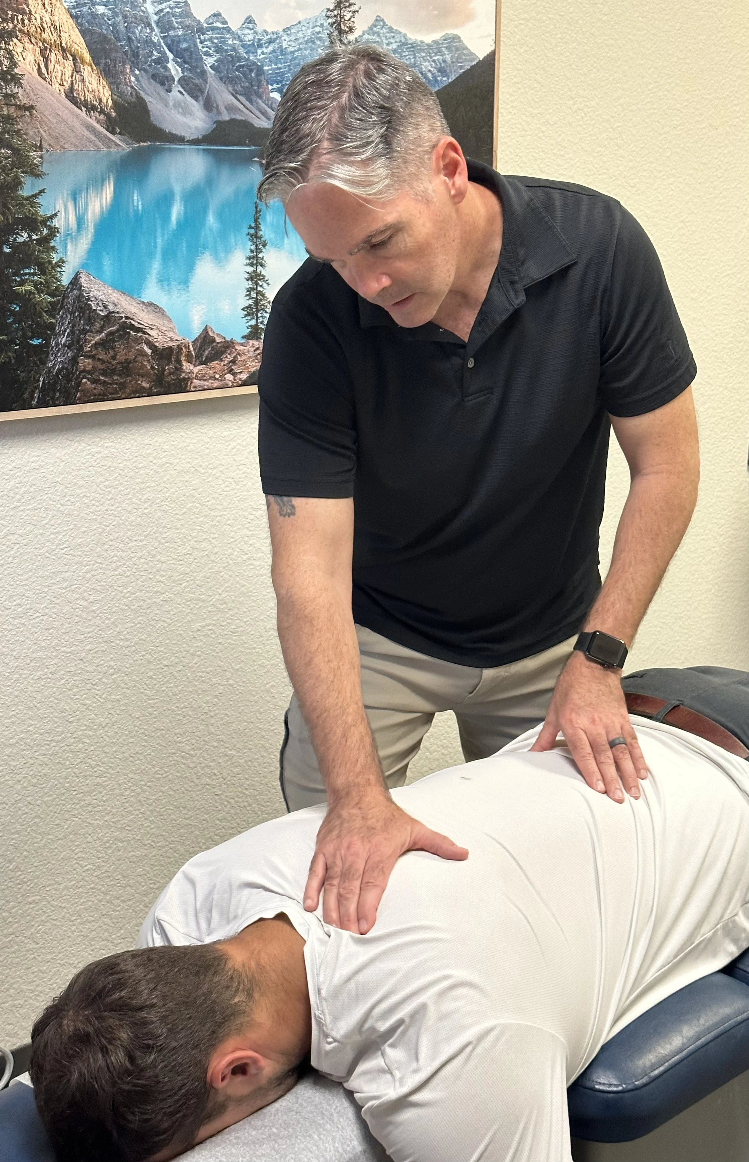 Chiropractor, Jeff Keon, working on man's back and spine. Relief for back pain in Sacramento, CA