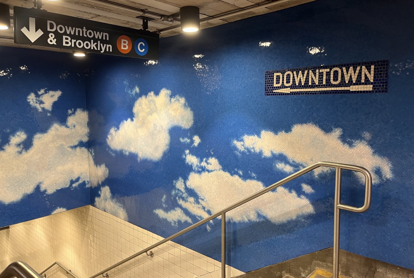 Mural of clouds made of tiles, in the NYC subway