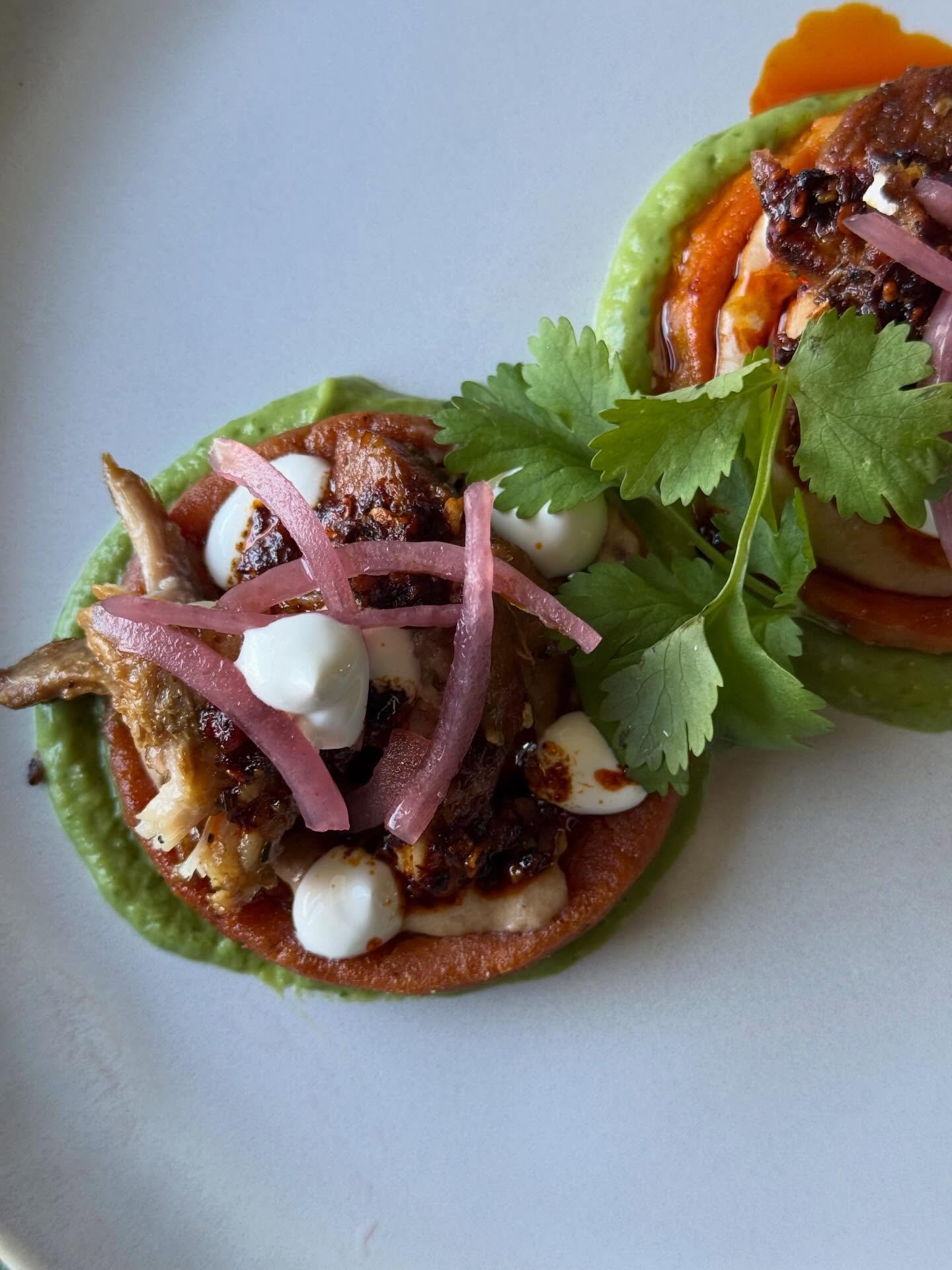 A new favorite just arrived in our nightly specials.🔥

Oaxacan sopes layered with heirloom refried beans and braised carnitas, finished with avocado mousse, cr&egrave;me fra&icirc;che, pickled onion, and a delicate touch of masa macha. Thoughtfully 