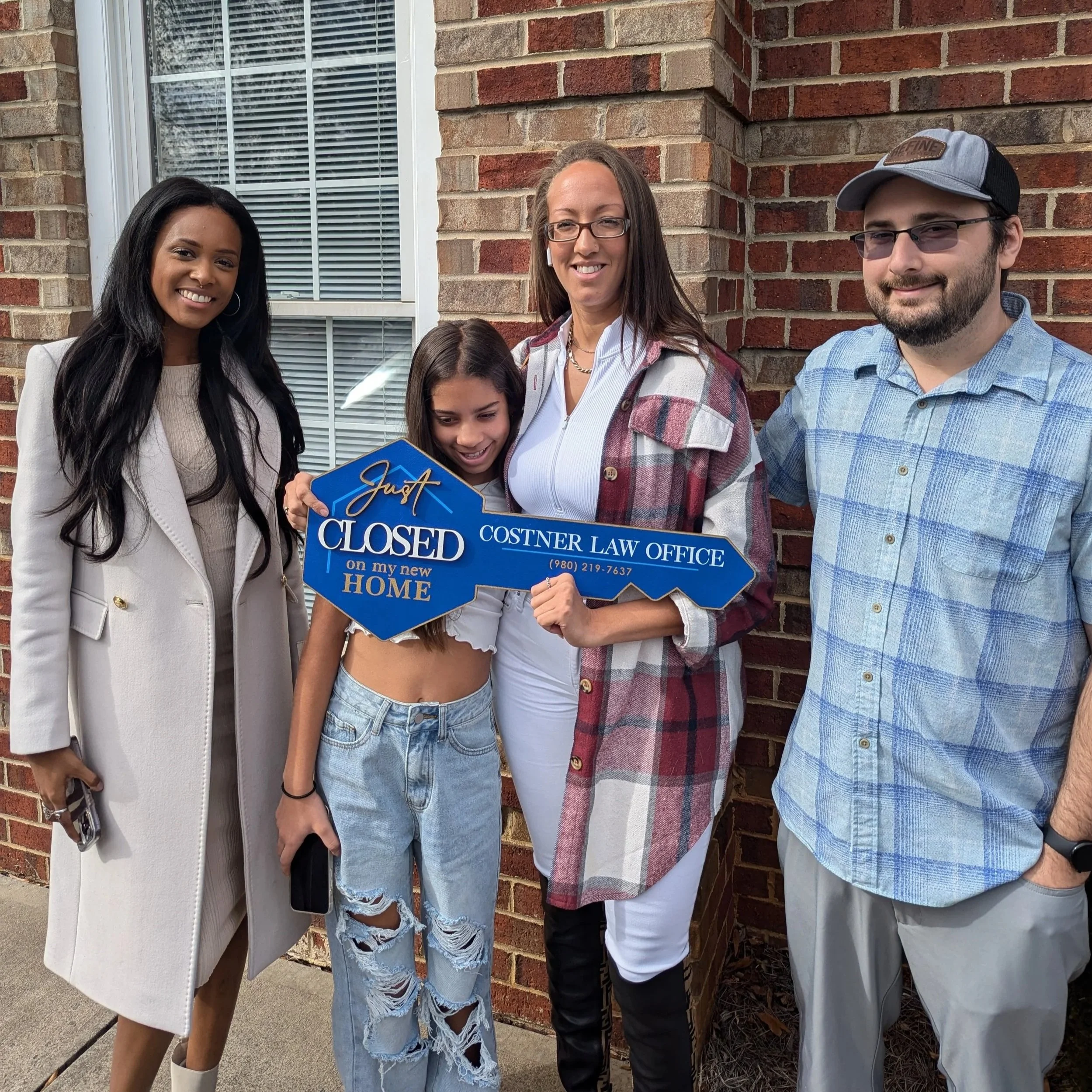 Homebuyer relocating from up north to Charlotte, NC, celebrating outside the home with Realtor Sia Small